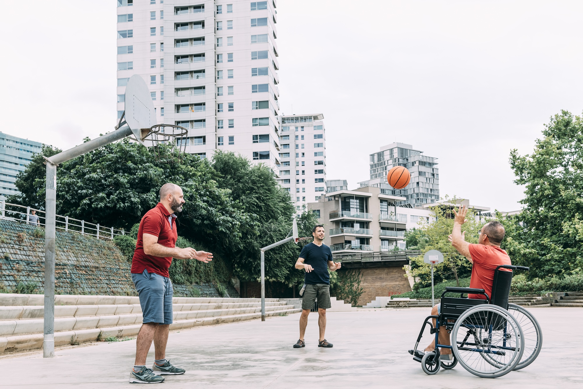 disabled man playing basketball with friends