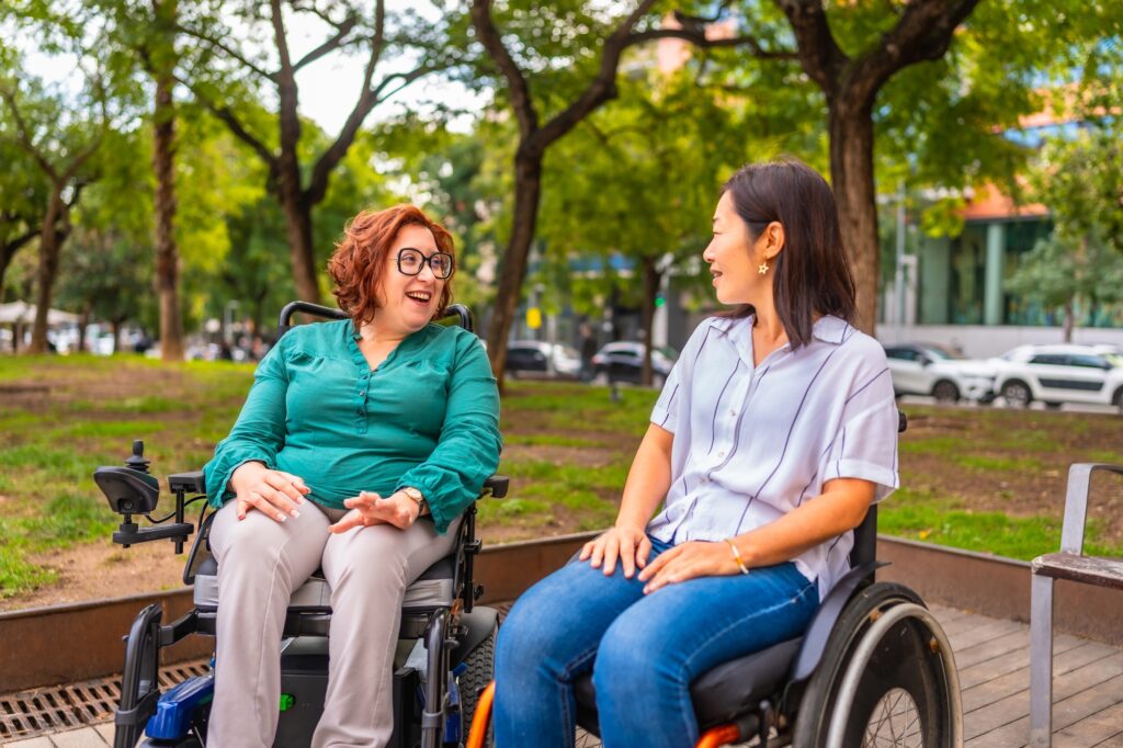 Multi-ethnic disabled people talking in the park