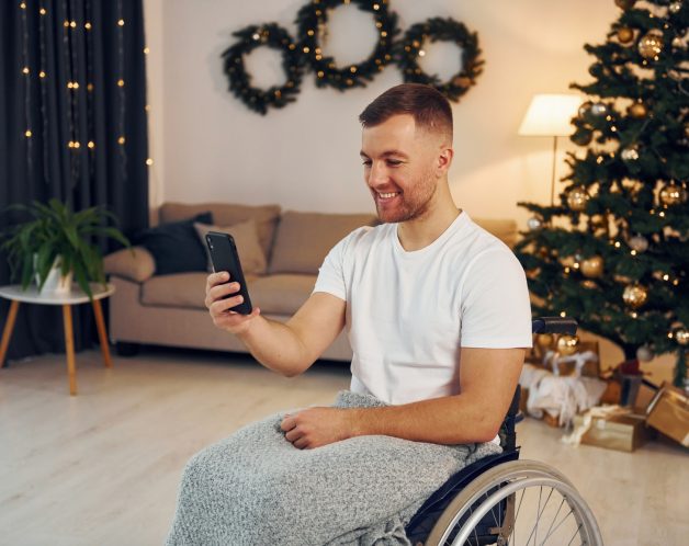 New year is coming. Disabled man in wheelchair is at home